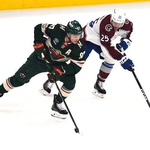 Minnesota Wild left wing Kirill Kaprizov (97) skates with the puck as Colorado Avalanche right wing Logan O'Connor (25) defends during the first period of Game 3 of an NHL Stanley Cup hockey second-round playoff series Saturday, May 9, 2026, in St. Paul, Minn. (AP Photo/Abbie Parr)