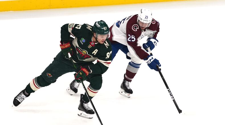 Minnesota Wild left wing Kirill Kaprizov (97) skates with the puck as Colorado Avalanche right wing Logan O'Connor (25) defends during the first period of Game 3 of an NHL Stanley Cup hockey second-round playoff series Saturday, May 9, 2026, in St. Paul, Minn. (AP Photo/Abbie Parr)