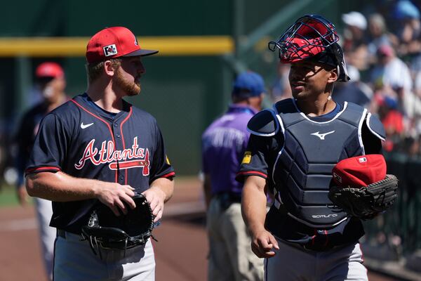 Braves pitcher Spencer Schwellenbach (left) chats with catcher Drake Baldwin after a spring training bullpen session in Arizona.