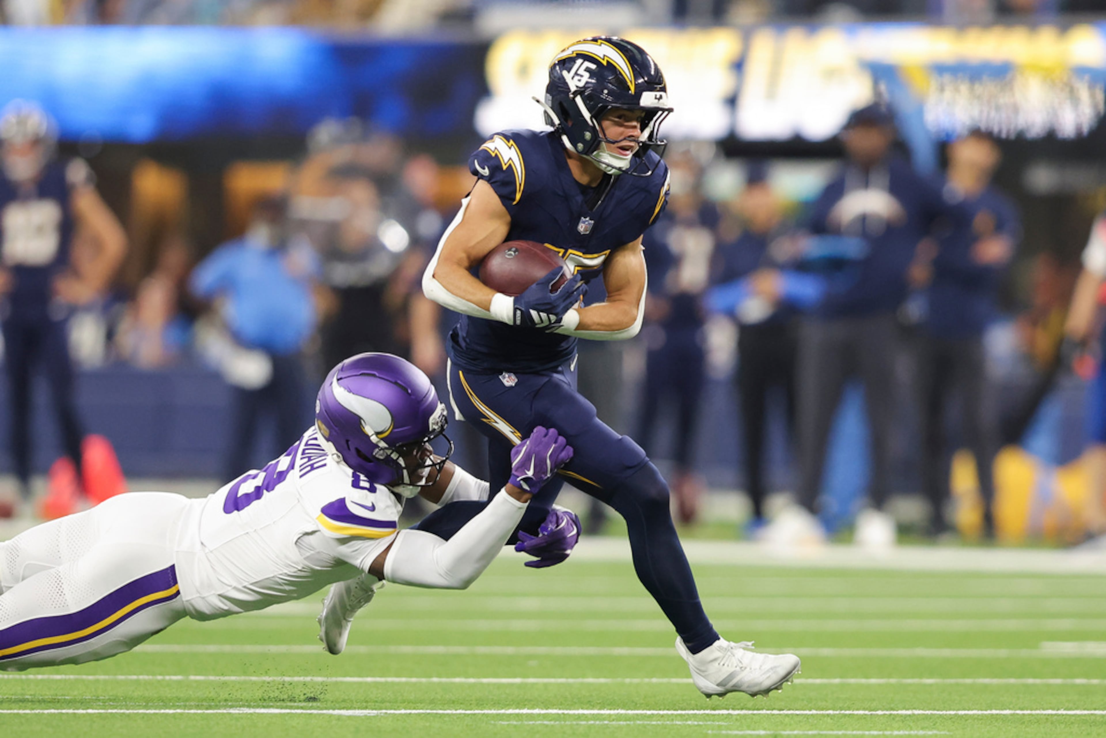 Los Angeles Chargers wide receiver Ladd McConkey, right, runs the ball as Minnesota Vikings cornerback Jeff Okudah, left, tackles during the first half of an NFL football game, Thursday, Oct. 23, 2025, in Inglewood, Calif. (Jessie Alcheh/AP)