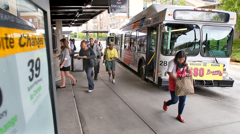 100927 Atlanta: Riders at the Lindbergh MARTA station had a sign posted enlisted the no-change and modified routes that became effective 9/25. While some MARTA riders may have learned the hard way that the trains won't start as early on weekends, others were adjusting to changes to their weekday commutes on Monday, Sept. 27, 2010. MARTA service reductions went into effect Saturday. The agency cut 10 percent of bus service and 14 percent of rail service as it tried to address an estimated $109 million deficit. Government and transit agencies across the country and metro Atlanta have faced cuts because of the tough economy. Fare increases for passes (for two to 30 days) and the final phase-out of tokens will happen at the beginning of October, and shuttles to Braves games and Lakewood Amphitheatre will be eliminated next year. Detailed maps posted on MARTA's website and at train stations show how bus routes will veer away from less-used paths, or take longer routes to pick up dropped portions of other buses. In general, train passengers will see slightly longer waits, and more who take branch lines will have to stop for transfers.. John Spink jspink@ajc.com