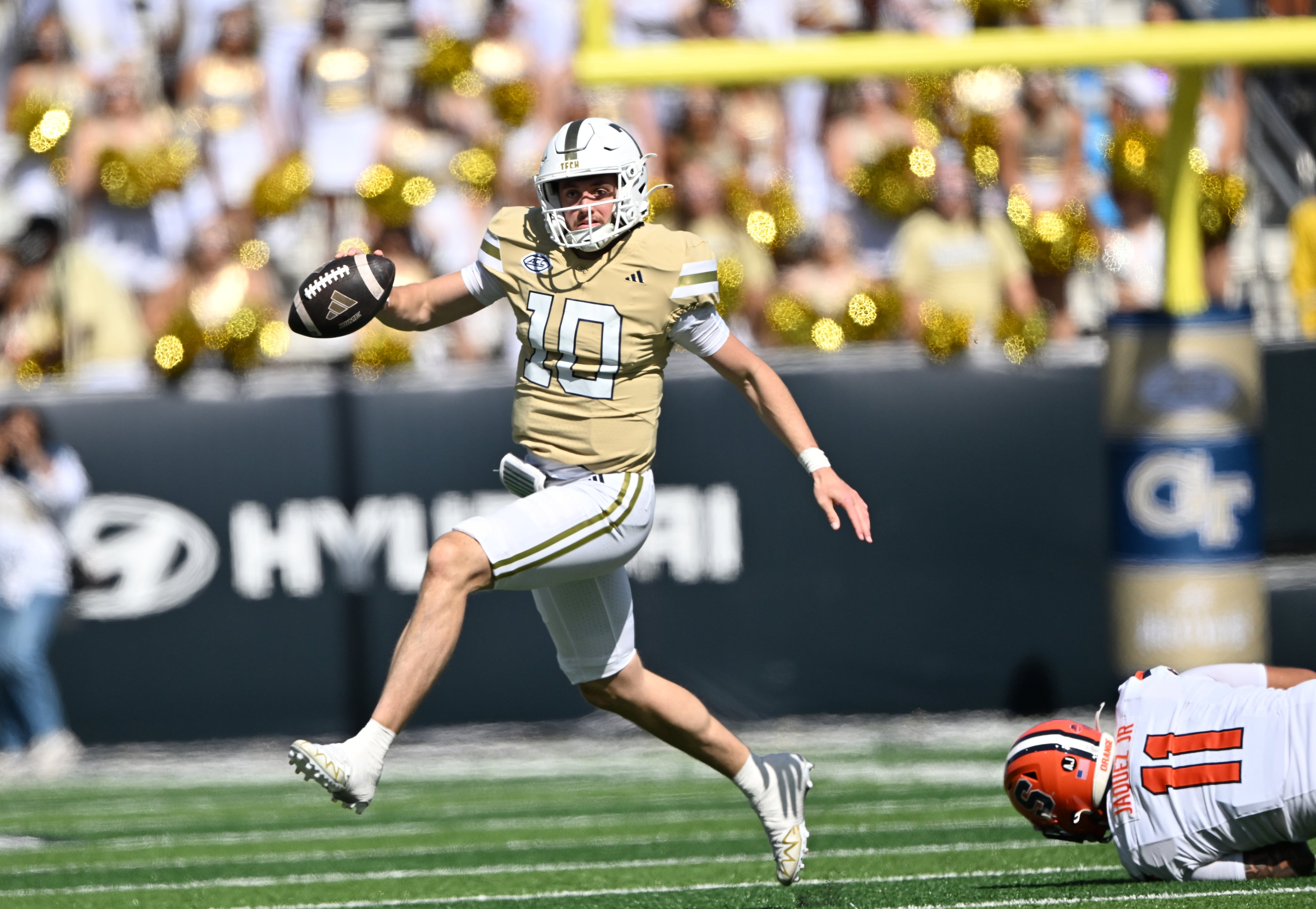 Georgia Tech quarterback Haynes King (10) runs the ball past Syracuse defensive lineman Denis Jaquez Jr. (11) during the first half of an NCAA college football game at Bobby Dodd Stadium, Saturday, October 25, 2025 in Atlanta. (Hyosub Shin / AJC)