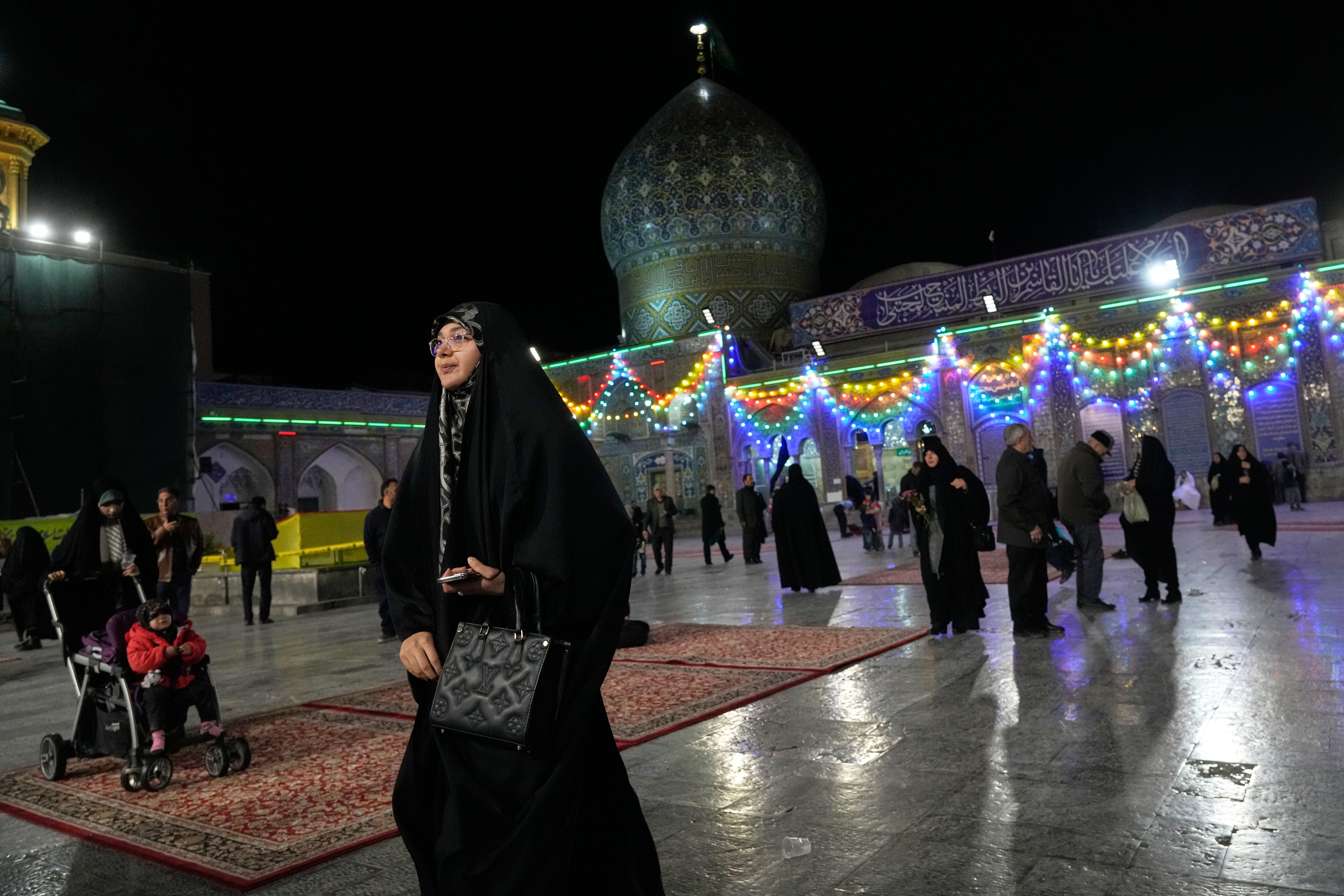 A woman walks through the Shiite Saints Abdulazim and Taher shrine in Shahr-e-Ray, south of Tehran, Iran, Thursday, Jan. 29, 2026. (AP Photo/Vahid Salemi)