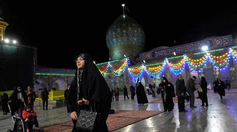 A woman walks through the Shiite Saints Abdulazim and Taher shrine in Shahr-e-Ray, south of Tehran, Iran, Thursday, Jan. 29, 2026. (AP Photo/Vahid Salemi)