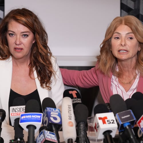 Lonna Drewes joins her lawyer Lisa Bloom at a news conference in Beverly Hills, Calif., Tuesday, April 14, 2026, to detail allegations of sexual misconduct by Rep. Eric Swalwell, after Swalwell exited the California governor's race and said he'll resign his seat in Congress. The AP typically does not identify people who say they are victims of sexual assault unless they identify themselves publicly. (AP Photo/Damian Dovarganes)