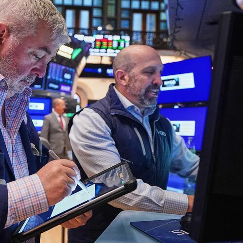 Trader Edward McCarthy, lefty dn specialist James Denaro work on the floor of the New York Stock Exchange, Wednesday, April 22, 2026. (AP Photo/Richard Drew)