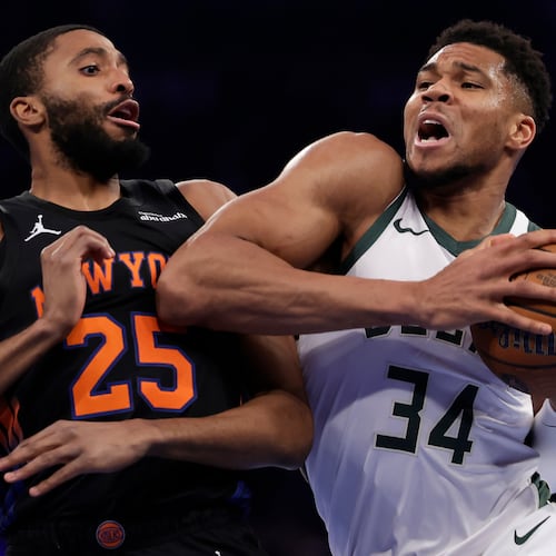Milwaukee Bucks forward Giannis Antetokounmpo (34) drives past New York Knicks guard Mikal Bridges (25) during the first half of an NBA Cup basketball game Friday, Nov. 28, 2025, in New York. (AP Photo/Adam Hunger)