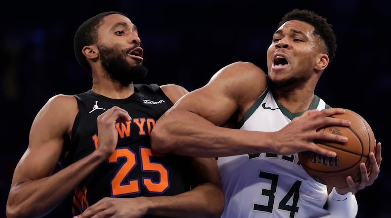 Milwaukee Bucks forward Giannis Antetokounmpo (34) drives past New York Knicks guard Mikal Bridges (25) during the first half of an NBA Cup basketball game Friday, Nov. 28, 2025, in New York. (AP Photo/Adam Hunger)
