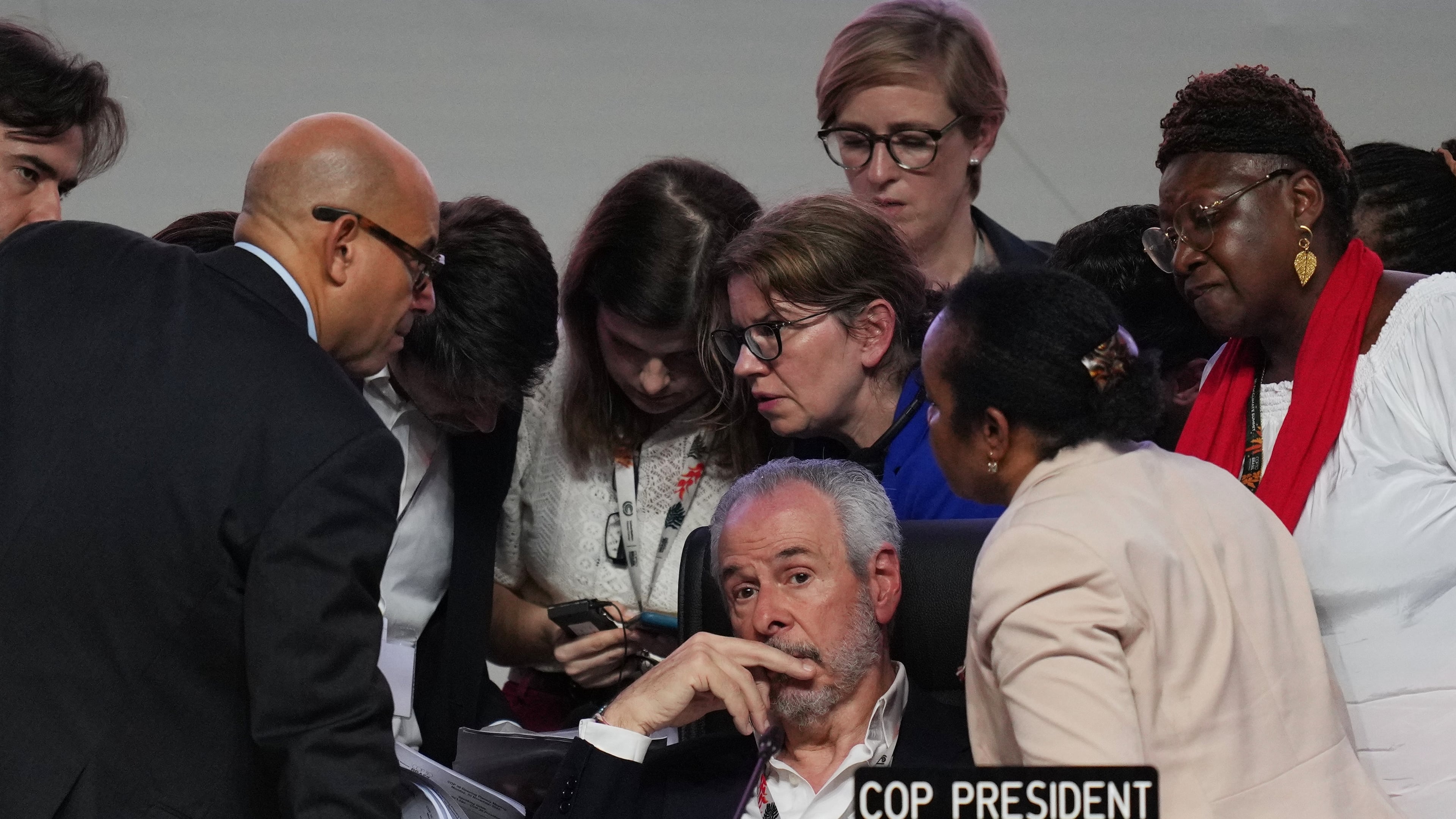 André Corrêa do Lago, COP30 president, sits as Simon Stiell, United Nations climate chief, left, speaks with other U.N. officials during a plenary session at the COP30 U.N. Climate Summit, Saturday, Nov. 22, 2025, in Belem, Brazil. (AP Photo/Andre Penner)