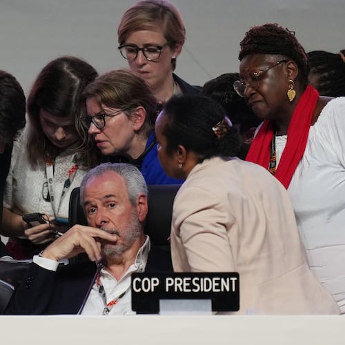 André Corrêa do Lago, COP30 president, sits as Simon Stiell, United Nations climate chief, left, speaks with other U.N. officials during a plenary session at the COP30 U.N. Climate Summit, Saturday, Nov. 22, 2025, in Belem, Brazil. (AP Photo/Andre Penner)