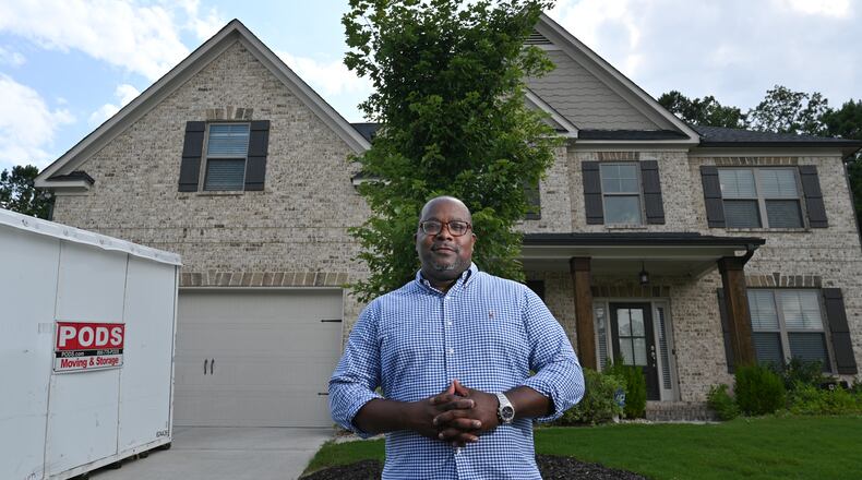 July 15, 2021 Lawrenceville - Portrait of Lavell Hewitt, a new homeowner who was lucky enough to score a home after selling his house to Opendoor at a higher than market price, outside his new home in Lawrenceville on Thursday, July 15, 2021. (Hyosub Shin / Hyosub.Shin@ajc.com)