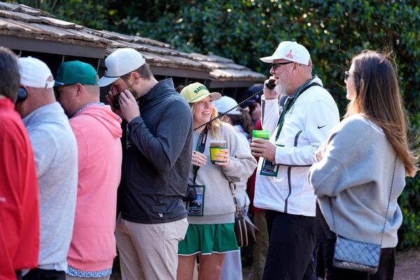 Patrons line up to use courtesy phones during a practice around at the Masters golf tournament, Wednesday, April 9, 2025, in Augusta, Ga. (AP Photo/Ashley Landis)
