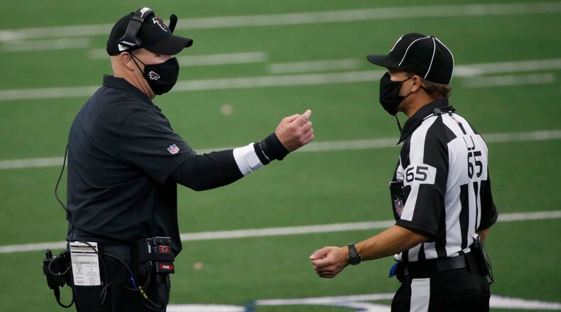 Falcons head coach Dan Quinn talks with referee Walt Coleman (65) in the second half against the Dallas Cowboys Sunday, Sept. 20, 2020, in Arlington, Texas. (Michael Ainsworth/AP)