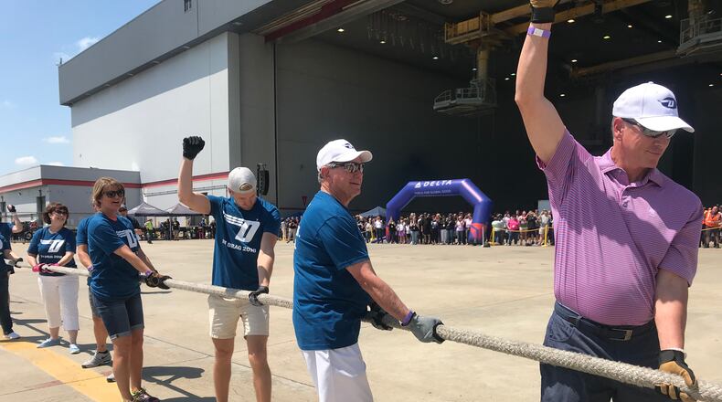 Tom Glavine helps a team pull a Boeing 757 for charity at a Delta event. KELLY YAMANOUCHI/KYAMANOUCHI@AJC.COM