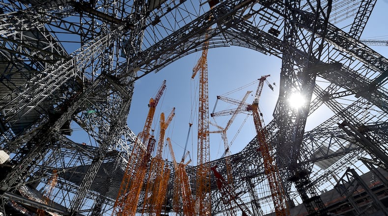 October 19, 2016 Atlanta: Construction crews celebrated the near completion of the the fixed roof at Mercedes Benz Stadium Wednesday October 19, 2016 by signing a beam and then lifting it into place. The completed stadium will use more than 27,000 tons of steel. Installation of the retractable roof will begin next. BRANT SANDERLIN/BSANDERLIN@AJC.COM