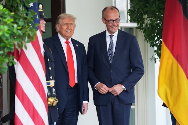 President Donald Trump, left, greets Germany's Chancellor Friedrich Merz at the White House, Thursday, June 5, 2025, in Washington. (AP Photo/Evan Vucci)