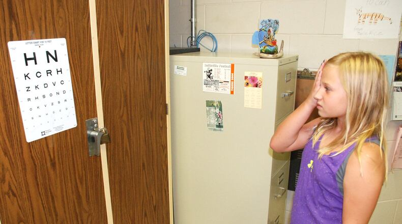 Joanna Gerken, 10, is given a free eye exam during the Back to School Health Fair held at Brown Primary on Aug. 14.
