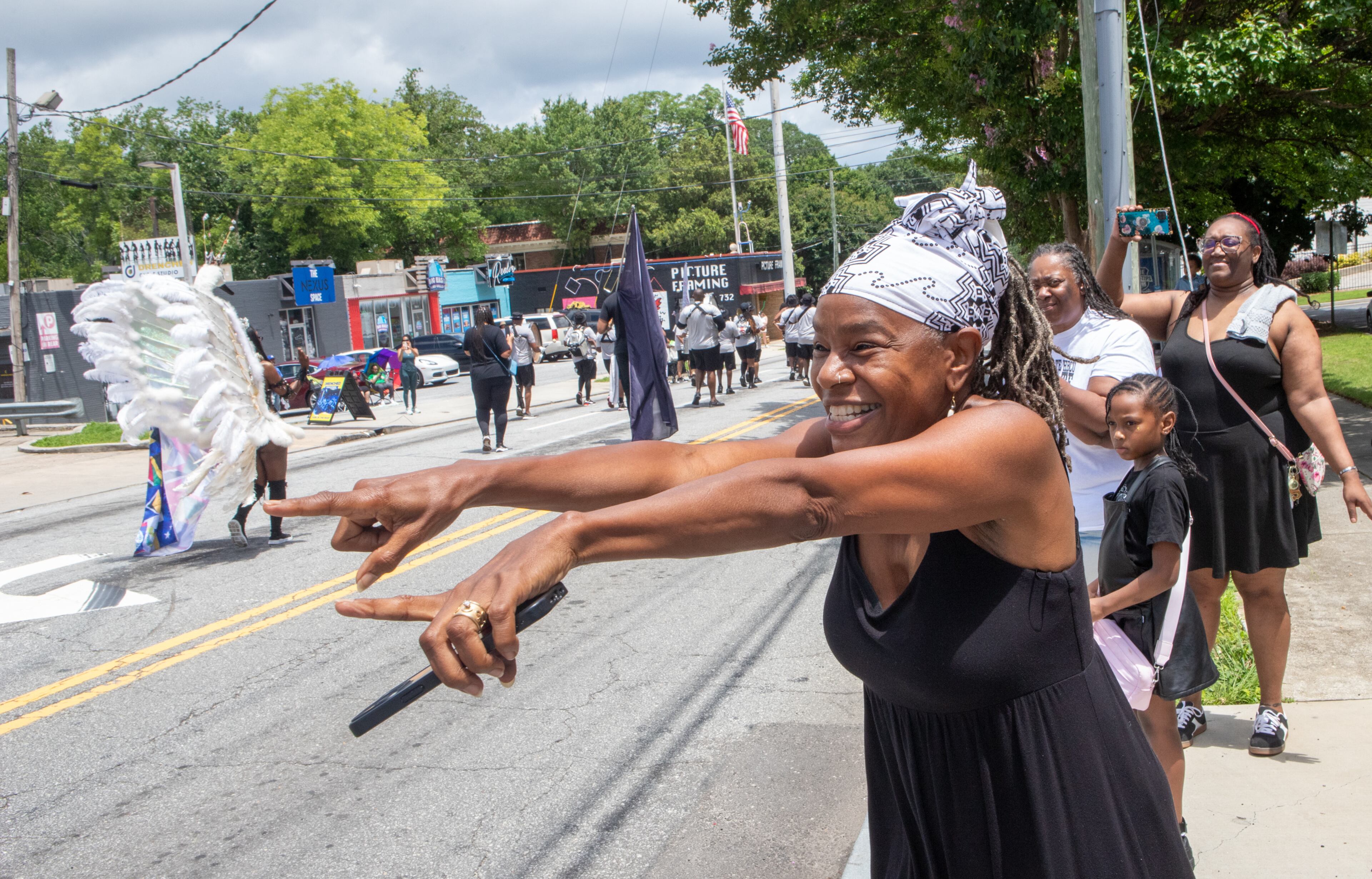 Huisha Kiongozi cheers on the Juneteenth Parade on Monroe Drive in Atlanta on Saturday, June 14, 2025. The annual parade began at The King Center and ended at Piedmont Park. (Jenni Girtman for The Atlanta Journal-Constitution)