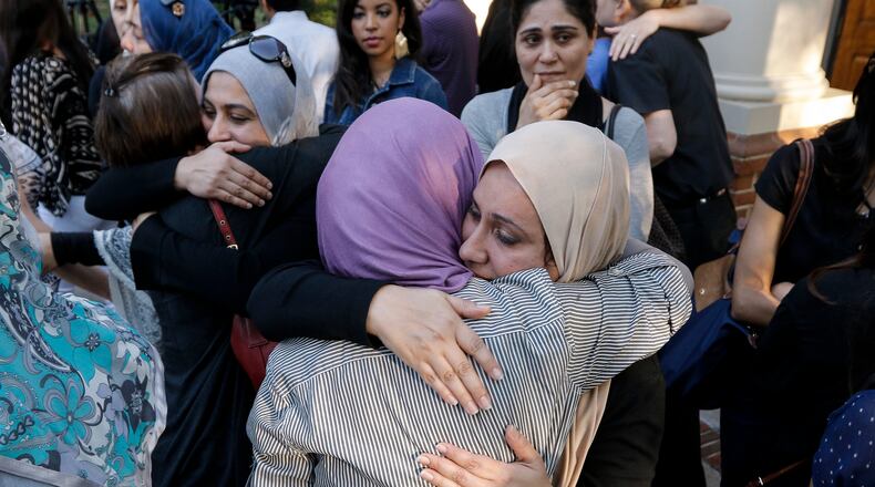 Women who came with others from the Islamic Society of Greater Chattanooga to offer their support hug outside after an interfaith vigil at Olivet Baptist Church held in remembrance of victims of the July 16 shootings on Friday, July 17, 2015, in Chattanooga, Tenn. The vigil was held one day after gunman Mohammad Youssef Abdulazeez shot and killed four U.S. Marines and wounded two others and a Chattanooga police officer at the Naval Operational Support Center on Amnicola Highway shortly after firing into the Armed Forces Career Center on Lee Highway. (Doug Strickland/Chattanooga Times Free Press/TNS)