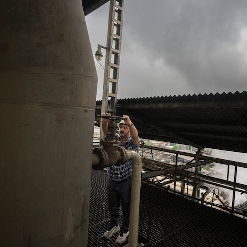 FILE - A technician releases a valve of a tank at Bajaj Hindustan Sugar factory that produces ethanol, a type of biofuel, in Meerut, India, Aug. 23, 2023. (AP Photo/Altaf Qadri, File)