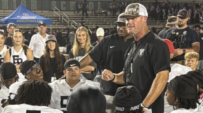 East Paulding coach Van Spence talks to his players after the Raiders' 27-23 victory over Harrison at Cobleigh Stadium on Aug. 28, 2026. (Chip Saye/AJC)