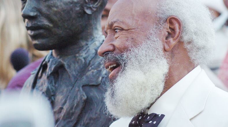 James Meredith, who integrated the University of Mississippi on Oct. 1, 1962, stands next to a statue of himself during a dedication ceremony of a civil rights monument in Oxford, Miss., on Oct. 1, 2006. (AP Photo/Oxford Eagle, Bruce Newman)