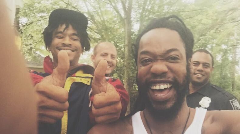 D.C.-based rapper Stefan Grant, also known as STEFisDOPE, posted a viral selfie with two DeKalb police officers to Twitter. The rapper was renting an Airbnb when a neighbor mistook the guests for robbers and called the cops.