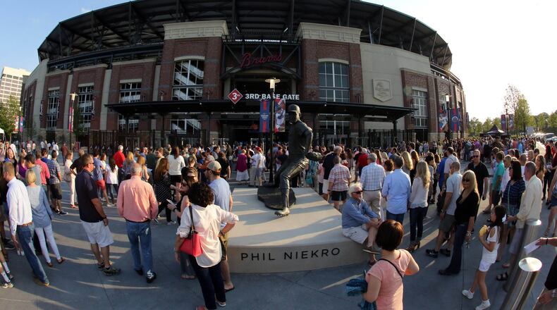 Fans wait to get inside SunTrust Park Friday night for Billy Joel, the first concert held at the baseball stadium. Photo: Robb Cohen Photography & Video