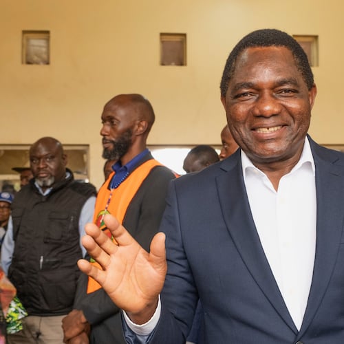 Zambia's President Hakainde Hichilema shares a light moment with journalists after casting his vote at a polling station in Lusaka, Zambia, Thursday, Aug. 13, 2026. (AP Photo/Anita Reed)