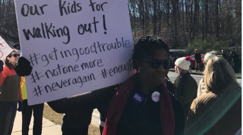 Walton High School parents showed up at the Cobb County school Wednesday to cheer  their children's walkout to honor the Parkland victims and decry gun violence.