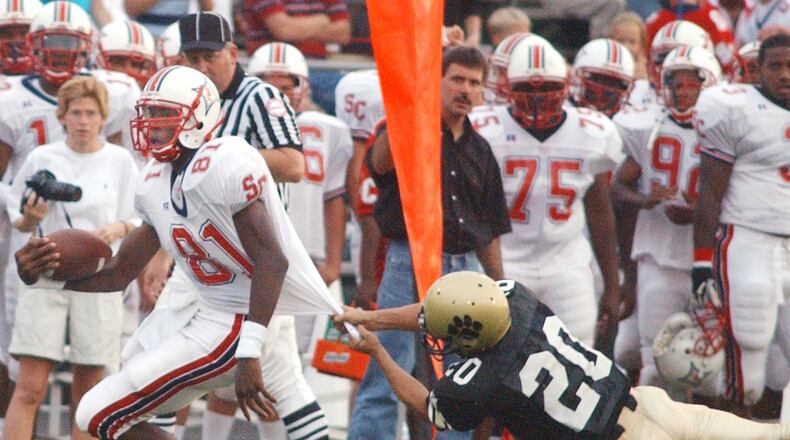 Sandy Creek receiver Calvin Johnson (81) gets away from a Fayette County defender for a first down during a game Friday, Sept. 5, 2003, in Fayetteville.  (Marlene Karas/AJC)