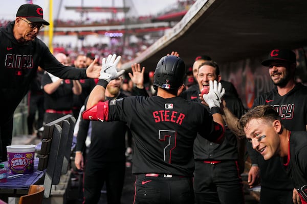 Cincinnati Reds' Spencer Steer (7) celebrates with teammates after hitting a two-run home run during the fifth inning of a baseball game against the San Diego Padres, Friday, June 27, 2025, in Cincinnati. (AP Photo/Jeff Dean)