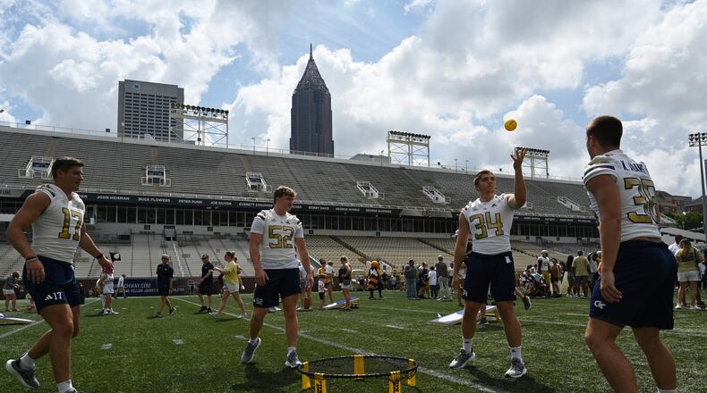 Georgia tech freshman football players enjoy tossing ball game during Georgia Tech football’s annual Fan Day at Bobby Dodd Stadium, Saturday, August 5, 2023, in Atlanta. First Saturday on The Flats presented by Georgia’s Own Credit Union – Georgia Tech football’s annual Fan Day event – featured a plethora of other interactive on-field activities for the whole family, including the opportunity to run out of the Georgia Tech tunnel onto the field like the Yellow Jackets do on gameday, a football toss, ladder drills, combine and tailgate games, an agility course, field goal kicking, a uniform station, 360-degree photo booth and more. (Hyosub Shin / Hyosub.Shin@ajc.com)