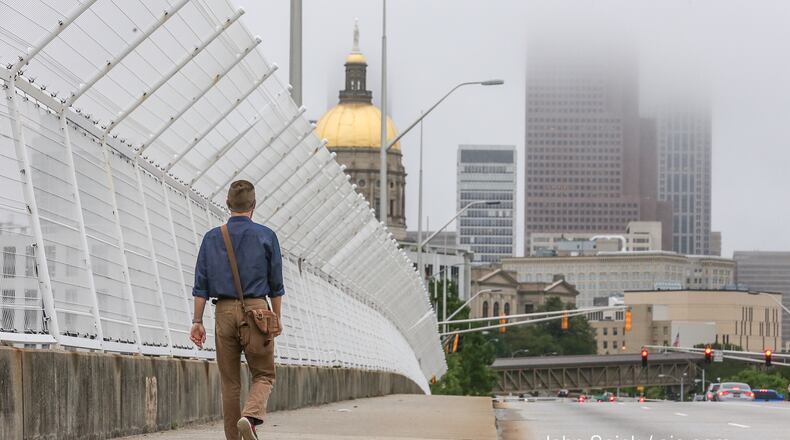 Chris Machold heads into work on Capitol Avenue in downtown Atlanta on a foggy day. JOHN SPINK / JSPINK@AJC.COM