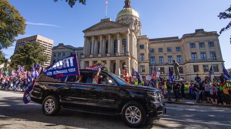 Cars and trucks with signs in support of President Donald Trump circle the state Capitol in Atlanta on Saturday, November 14, 2020. (Photo: Steve Schaefer for The Atlanta Journal-Constitution)