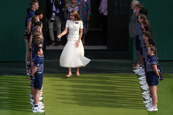Britain's Kate, the Princess of Wales, arrives to hand over the trophy to Iga Swiatek of Poland after winning the women's singles final match against Amanda Anisimova of the U.S. at the Wimbledon Tennis Championships in London, Saturday, July 12, 2025.(AP Photo/Joanna Chan)