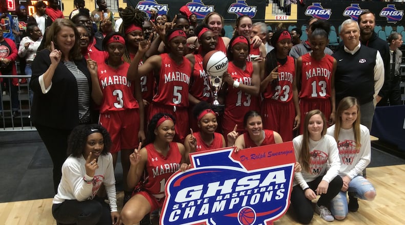 Marion County coach Fran McPherson (left) and her team celebrate their 50-38 victory over Calhoun County in the Class A private-school final Wednesday at the Macon Coliseum that gave the Eagles their first girls basketball state championship in school history.
