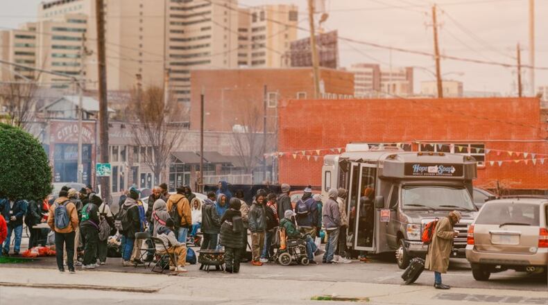 Hope thru Soap offers mobile showers and clothing for men, women and children experiencing homelessness. Held prior to covid, a block party in Atlanta where they also provided haircuts, a hot lunch and Outreach Services is shown.
