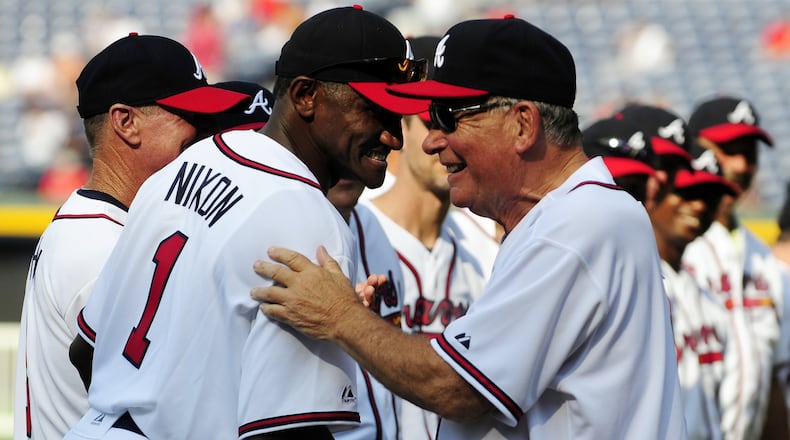 In this Aug. 13, 2011 file photo, former Atlanta Braves player Otis Nixon, left, is greeted by former Braves manager Bobby Cox during a Braves Legends Game. (Associated Press photo)