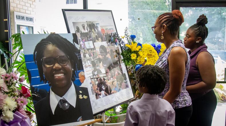 People look over the flowers and photographs before the start of funeral services Saturday for Imani Bell at the Hillside Chapel & Truth Center in Atlanta August 24, 2019. (Photo: STEVE SCHAEFER / SPECIAL TO THE AJC)