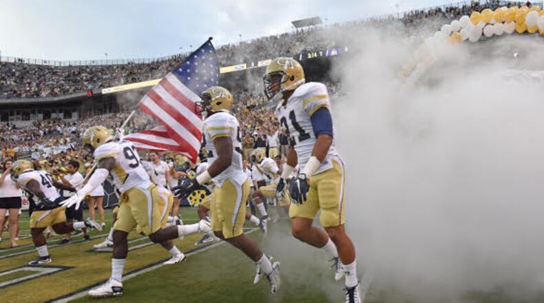 Georgia Tech players run on to the field before the start of the Georgia Tech season opener against the Alcorn State Braves in Bobby Dodd Stadium on Thursday, September 3, 2015. HYOSUB SHIN / HSHIN@AJC.COM