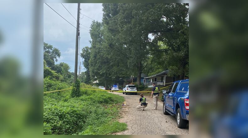 GBI agents investigate a scene in LaGrange at the request of the police department after officers shot and injured Reginald Saffold, who they say hit his wife with his car.
