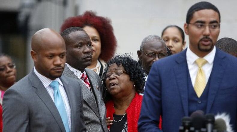 Judy Scott (center), Walter Scott’s mother, is comforted by her son Rodney Scott, as the family attorneys, Chris Stewart (left) and Justin Bamberg (right), hold a press conference after the mistrial was declared for the Michael Slager trial Monday in Charleston, S.C. A former patrolman, Slager, is charged with murder in the shooting death of Walter Scott last year. AP PHOTO / MIC SMITH