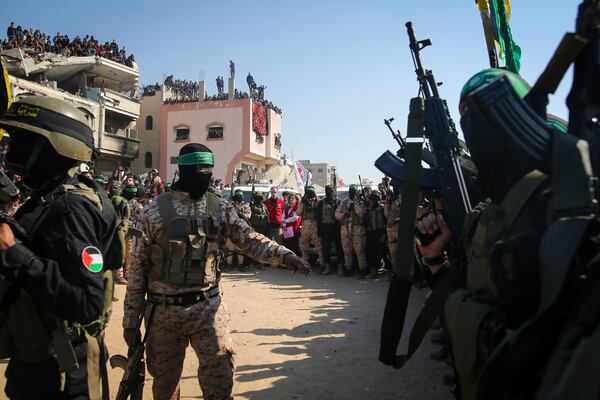 FILE - Hamas and Islamic Jihad militants secure the area as Red Cross representatives wait for the handover of Thai and Israeli hostages in Khan Younis, southern Gaza Strip, Thursday Jan. 30, 2025.(AP Photo/Jehad Alshrafi, File)