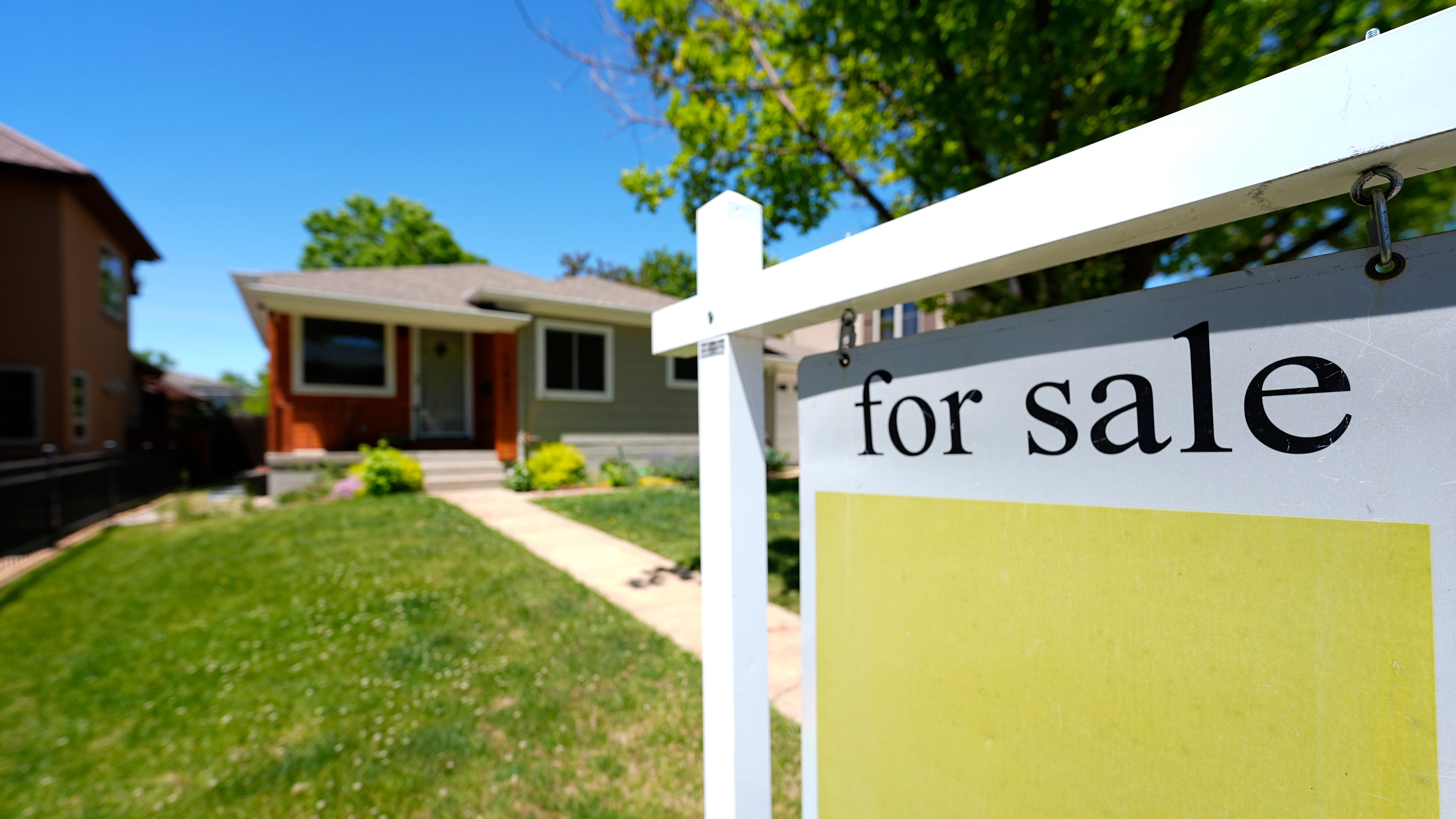 FILE - A for sale sign stands outside a single-family residence on the market May 22, 2024, in southeast Denver. (AP Photo/David Zalubowski, File)