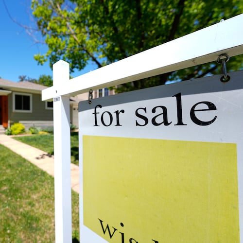 FILE - A for sale sign stands outside a single-family residence on the market May 22, 2024, in southeast Denver. (AP Photo/David Zalubowski, File)