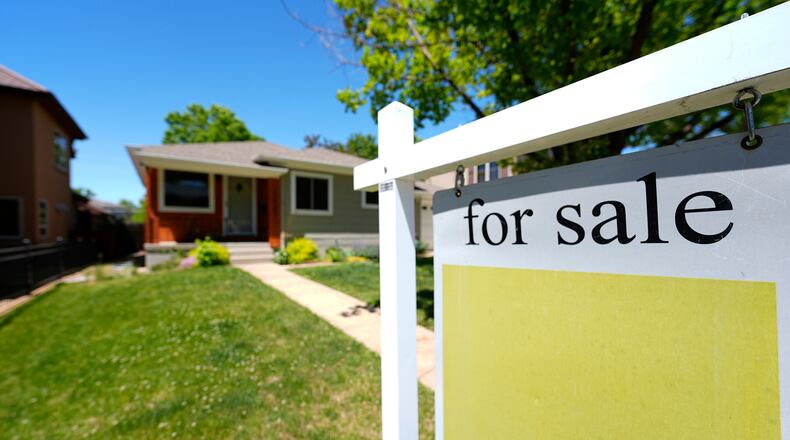 FILE - A for sale sign stands outside a single-family residence on the market May 22, 2024, in southeast Denver. (AP Photo/David Zalubowski, File)