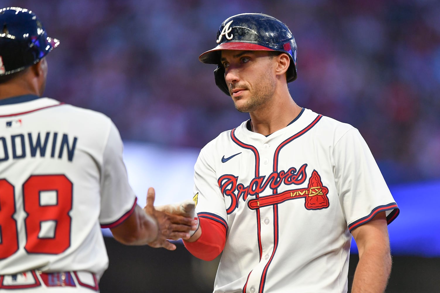 Atlanta Braves first base Matt Olson (28) high fives first base coach Tom Goodwin (88) after hitting a single to right field against the Mets during a MLB game Wednesday, June 18, 2025 at Truist Park. (Daniel Varnado/For the Atlanta Journal-Constitution)