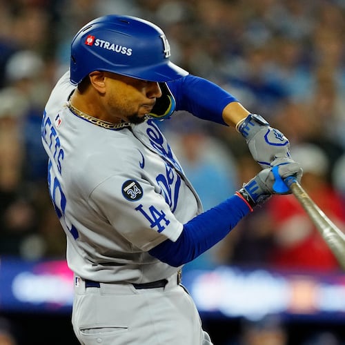 Los Angeles Dodgers' Mookie Betts (50) hits a two-run single against the Toronto Blue Jays during the third inning in Game 6 of baseball's World Series in Toronto on Friday, Oct. 31, 2025. (Frank Gunn/The Canadian Press via AP)