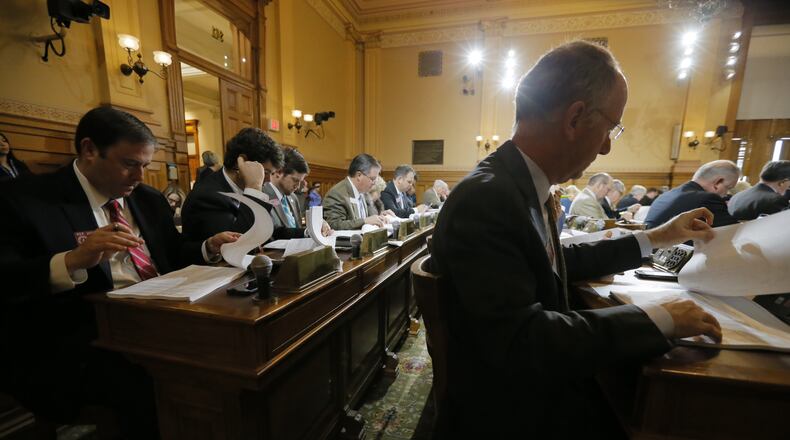 Georgia House Appropriations Committee members read through the tracking sheet for the fiscal 2018 state budget Thursday before voting to approve the $25 billion spending plan. BOB ANDRES / BANDRES@AJC.COM